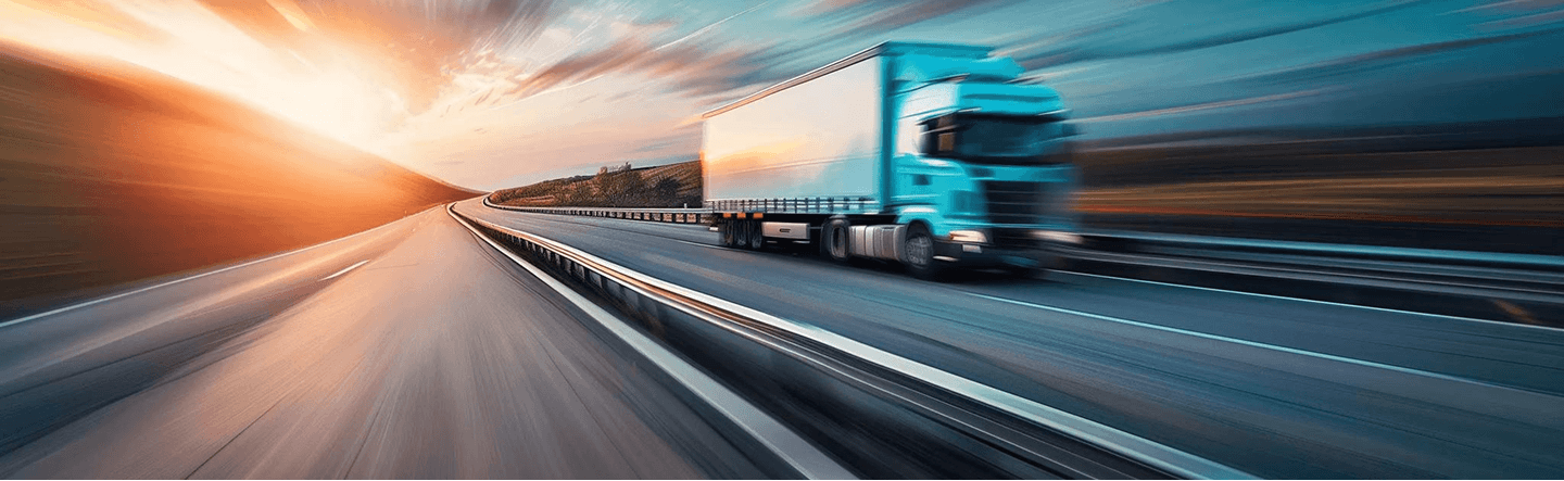 Semi truck driving on a highway at sunset